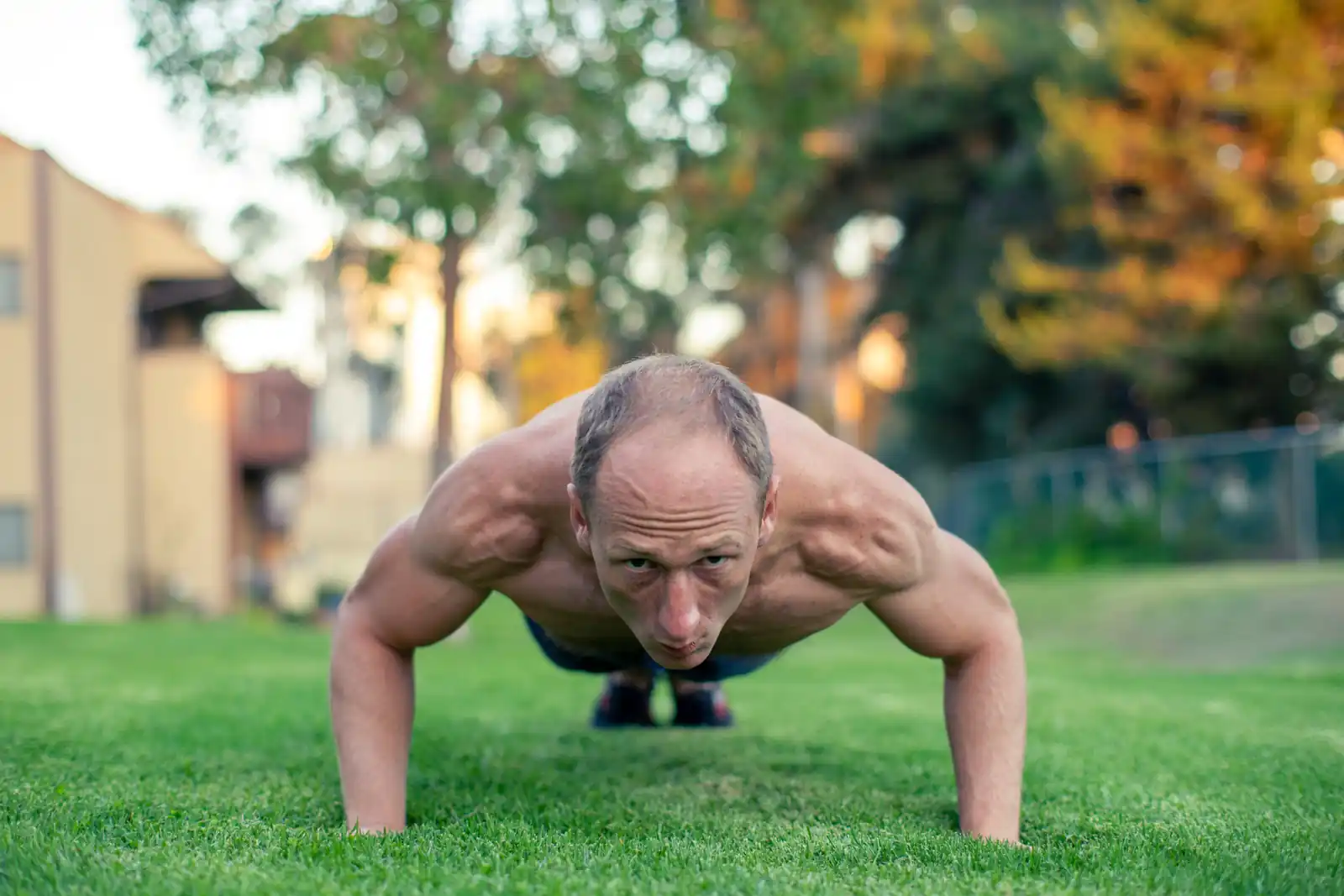 Busy dad performing a bodyweight burpee during a minimalist home workout